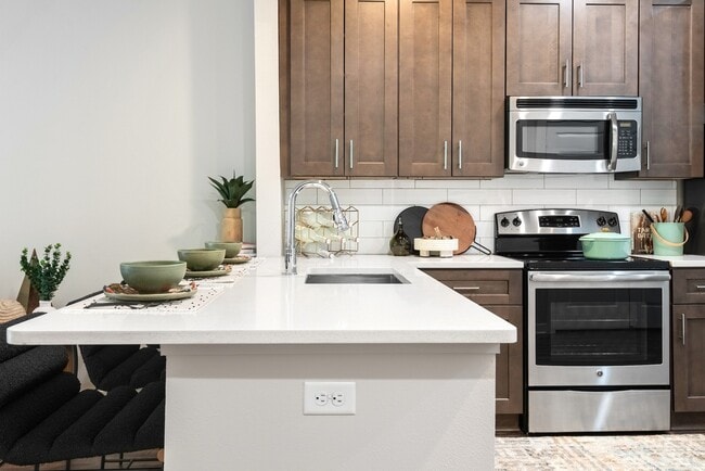 Modern Kitchen with Stainless Steel Appliances and Dark Wood Cabinets - Lamar Union