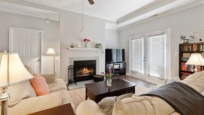 inviting living room with vinyl hardwood floors, fireplace and french doors - Apartments at Glenmoore
