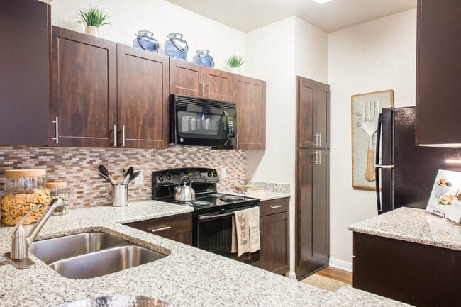 Austin TX Apartments for Rent - Large Kitchen Fully Equipped with Amenities Such As Fridge, Stove, and Microwave Also Featuring Plenty of Storage and Counter Space - Abelia Flats