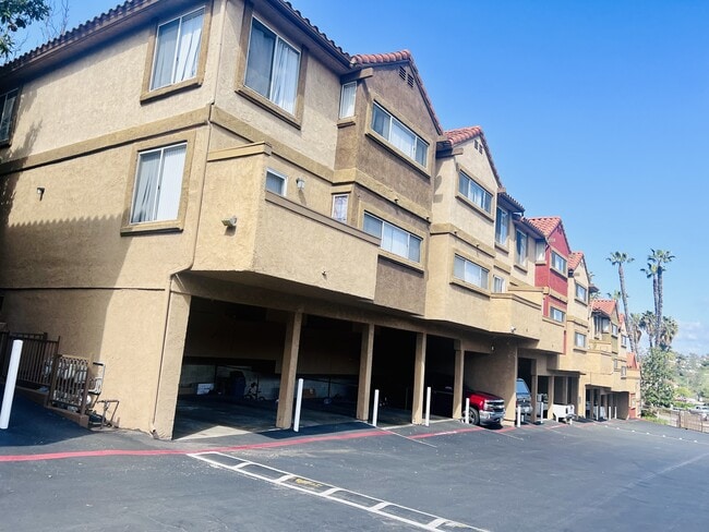 Parking with locked storage under townhome units at Grande Vista Apartments. - Grande Vista Apartments