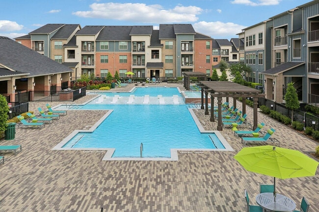Enjoy sunny days by the shimmering pool at Cityscape Apartments in Houston, Texas. - Cityscape