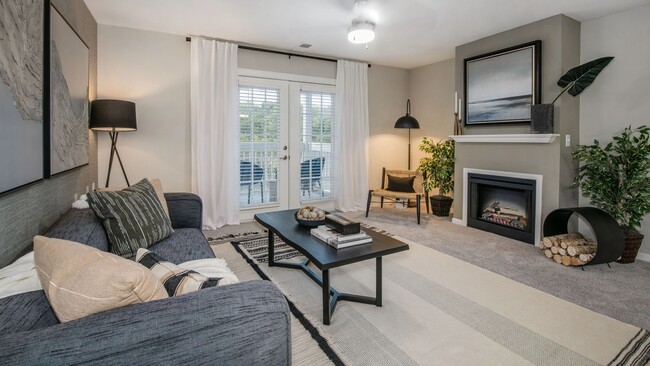 Bask in extra spacious living rooms leading to private patios/balconies, adorned with exquisite fireplaces (in select homes). - Lenox West Luxury Apartments