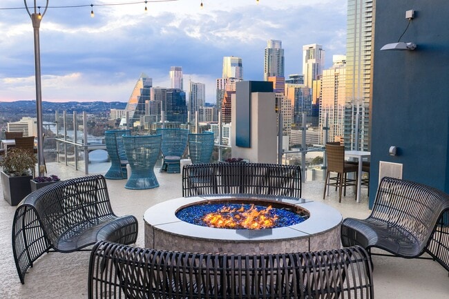 Rooftop lounge with large fire pit and Downtown Austin views - SkyHouse Austin