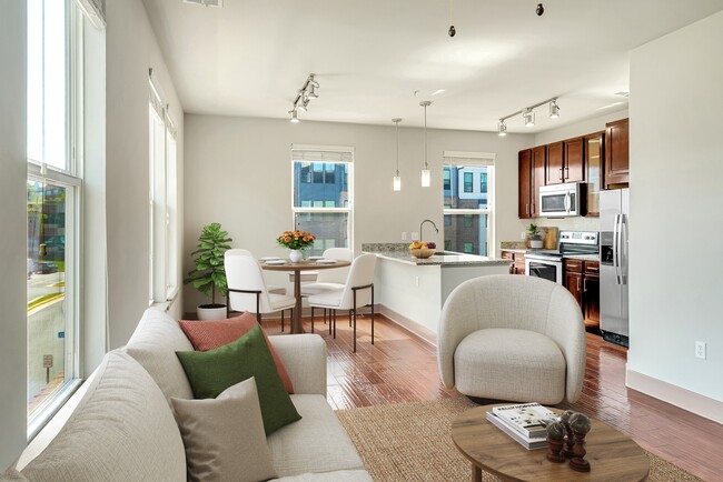 A modern living room with a white couch and a coffee table. - ICON at Dulles