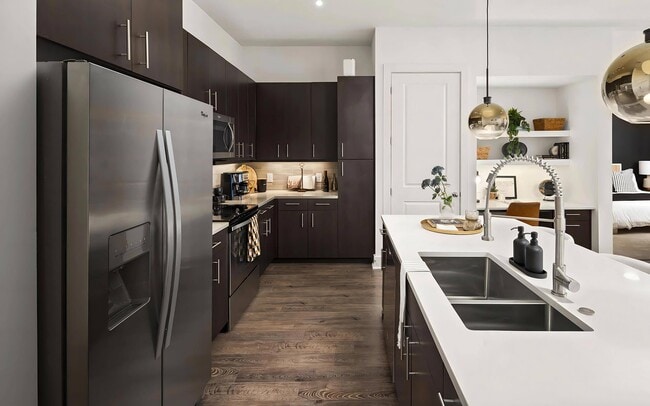 Stylish Kitchen with Stainless Steel Appliances and Dark Wood Cabinetry - Tens on West