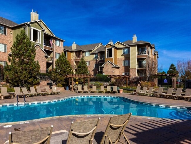 Pool with Sun Deck and Lounge Chairs - Indigo Creek&nbsp;Apartments