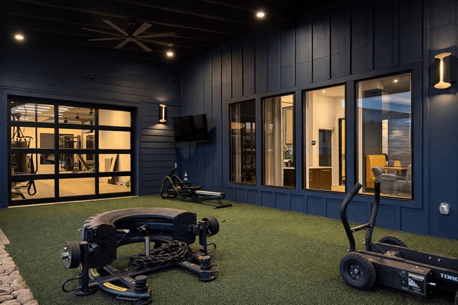 Open the roll-up door to extend your workout into the fresh air at Cypress Point. - Cypress Point