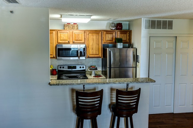 Convenient Bar Opens into Kitchen - Windsong Place Apartments