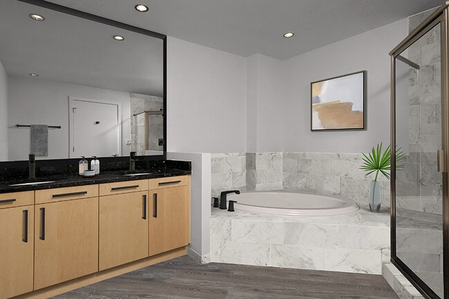 Bathroom upgrades include framed mirrors and marble-look porcelain tile surround. - Zoso Flats