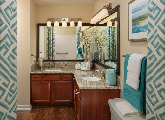 Bathroom with wood style flooring and granite countertops - Wood Bridge Apartments