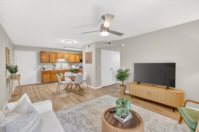 Open-concept living room with dining space at Saddlebrook Apartments - Saddlebrook Apartments