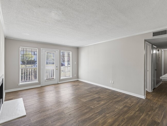 Bright living spaces feature sliding glass doors for easy access to outdoor areas, professionally operated by Highlands Vista Group. - Park at Meadow Ridge