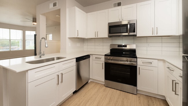 Kitchen with island and hard surface flooring - Kia Ora Park