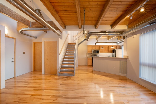 Exposed Beams & Wood Floors - Amber Town Center Townhomes & Lofts