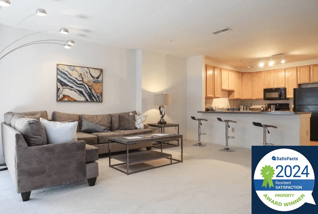 Symphony Center Apartments Living Room Interior with Resident Satisfaction Award Logo Banner - Symphony Center Apartments