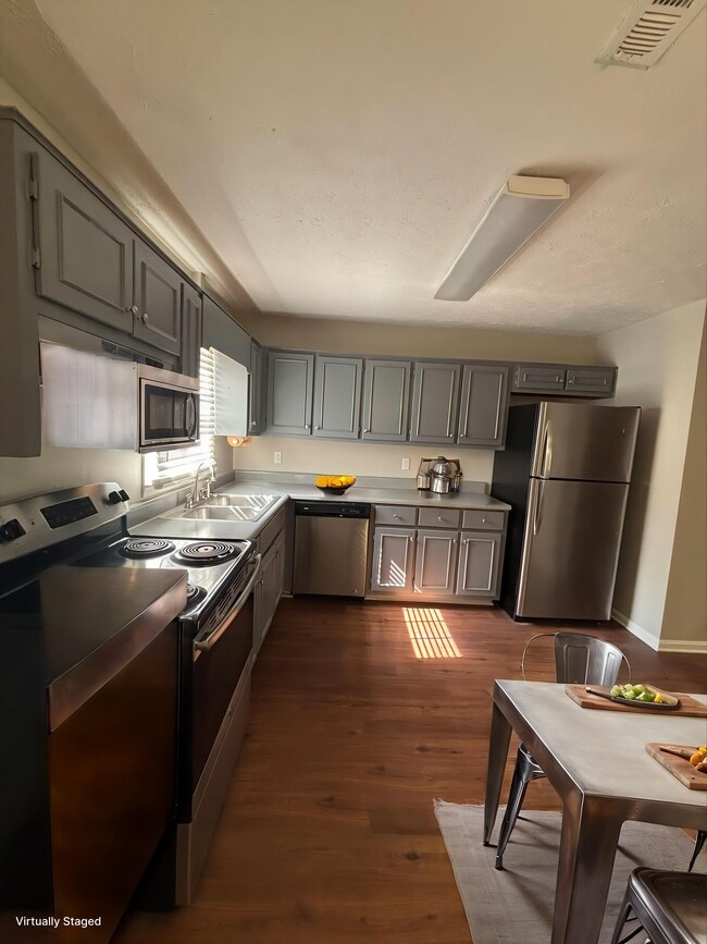Step into the inviting kitchen of Guest House, featuring modern stainless steel appliances and spacious countertops ideal for culinary adventures. Enjoy the warmth of natural light that enhances the welcoming atmosphere. Schedule your visit today! - Guest House