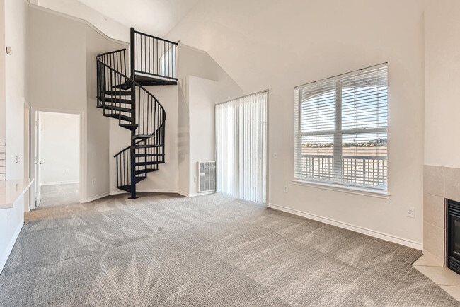 A Living Room with a Spiral Staircase at Fox Run Lofts - Fox Run Lofts