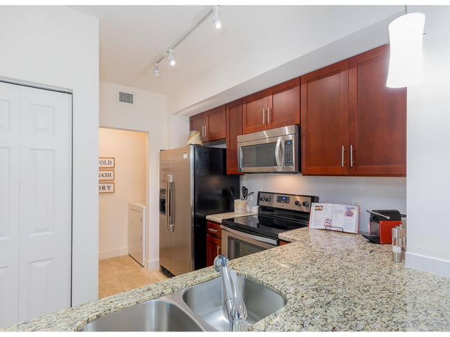 Gourmet kitchens with stainless steel appliances - AMLI Toscana Place