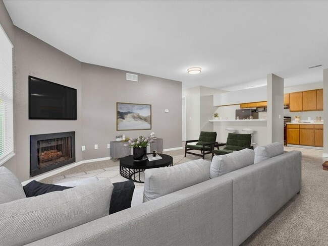 This living room is ideal for entertaining, relaxing, or simply enjoying the sense of openness that makes the home feel larger and more connected. - Wyndham Hill