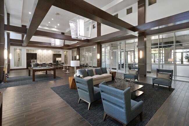 Expansive seating area with TV gallery located in resident game lounge - ICON at Ross