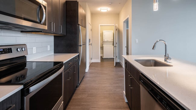 Kitchen with Stainless Steel Appliances and In-home Washer and Dryer - The Reserve at Burlington