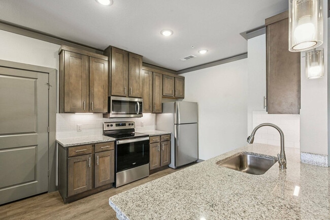 The kitchens at Cityscape Apartments include granite countertops, modern cabinetry, and open layouts. - Cityscape Apartments