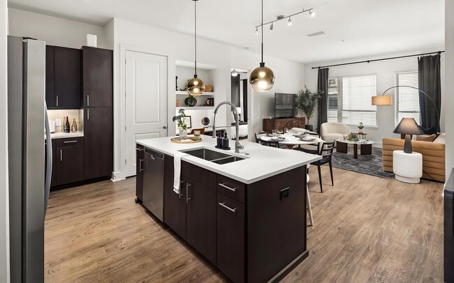 Apartment Kitchen and Living Area With Wood Flooring and Dining Setup - Tens on West