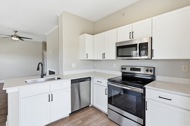 Cook, dine, and gather in a stylish kitchen space. - Grove at Cherry Creek Park