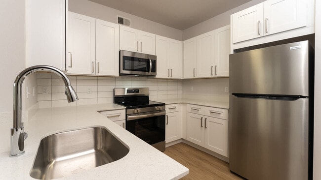 Kitchen with island and hard surface flooring - Kia Ora Park