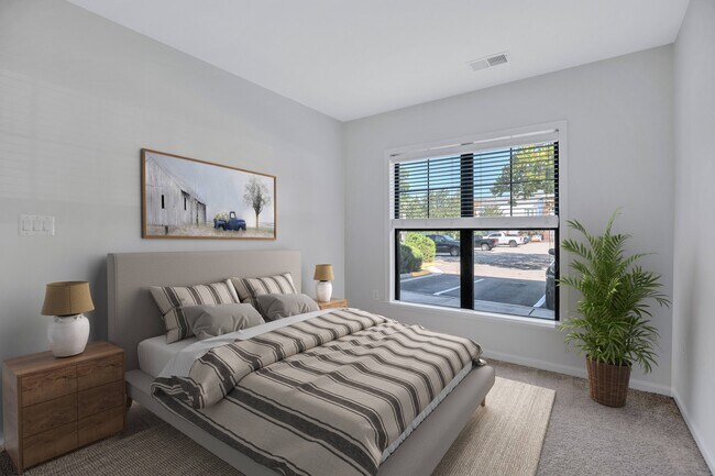 Spacious bedroom with plush carpeting - The Cosmopolitan at Lorton Station