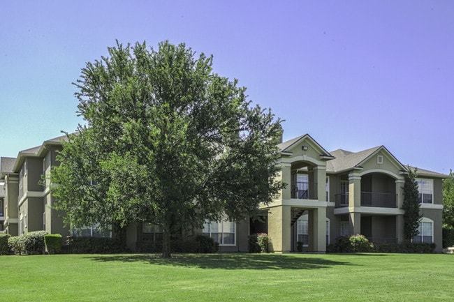 Landscaped Grounds with mature trees and seasonal color change - Legends at Chase Oaks