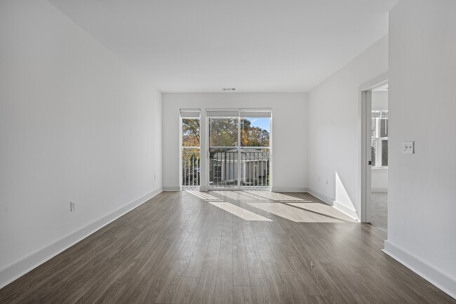 Afternoon light reaches most of the floor through the sliding door alone. - The Landing at Vinnin Square