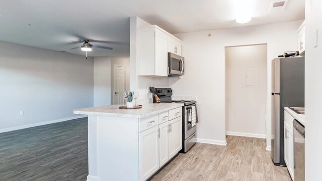 Discover a culinary oasis in our one-bedroom floor plan with a galley-style kitchen. Granite-style countertops and stainless steel appliances elevate your cooking experience. - Market 1900 Apartment Homes