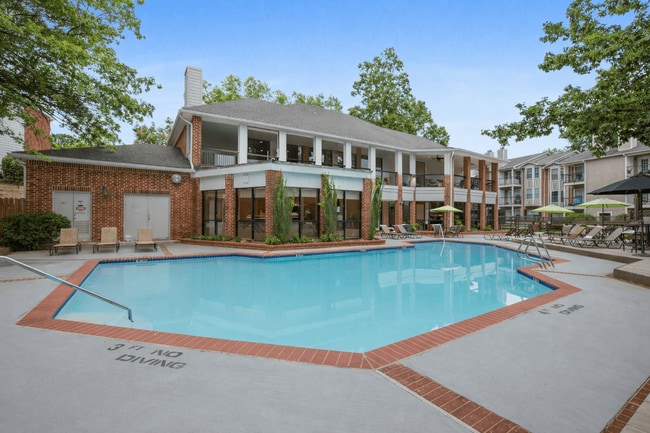Pool Side Relaxing Area Surrounded by Trees - Rolling Brook Village