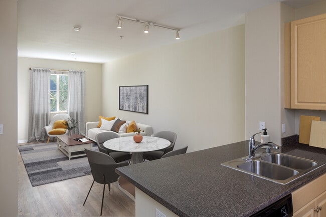 Kitchen, living, dining areas with hard surface flooring - Avalon Warner Place