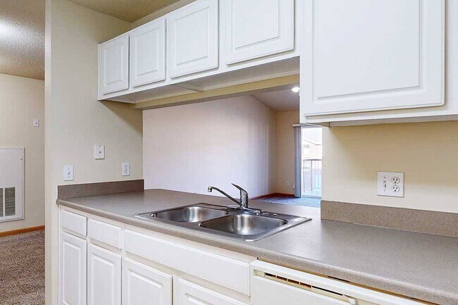 Our kitchens offer a functional design with ample cabinetry and counter space, making meal prep and organization effortless. - Northbrook Apartments