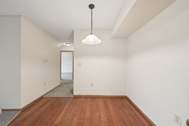 Dooley's Orchard apartment unit showing a dining area off the kitchen, with a hallway leading to a bathroom and bedroom. - Dooley's Orchard