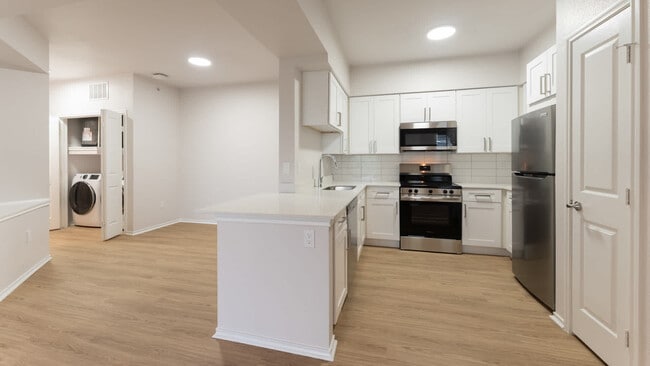 Kitchen with island and hard surface - Kia Ora Park
