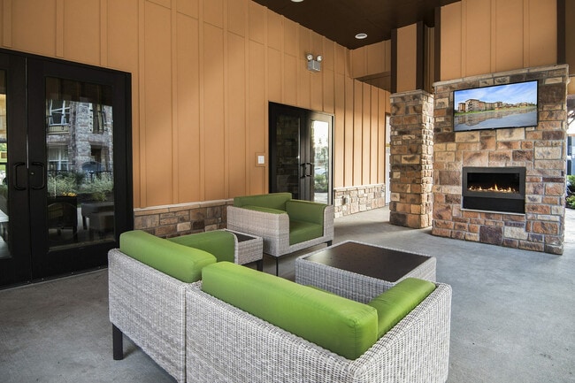 Enjoy the warmth of our stone fireplace and modern seating. - Watermark at Jordan Creek