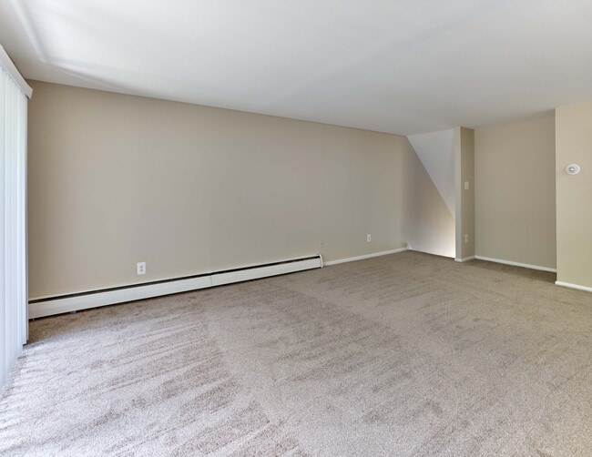 Spacious living room with plush carpet and open layout at Maple Terrace Apartments in Maple Shade, NJ - Maple Terrace