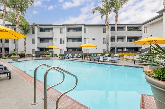Experience luxury living, where our pool area is a vibrant retreat. From the cheerful yellow umbrellas to the updated tables and chairs, every detail is designed for your relaxation and enjoyment. - Cornerstone Apartment Homes