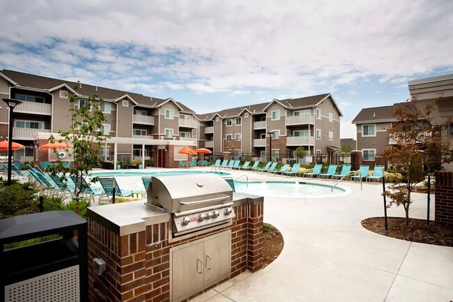 Enjoy resort-style living at SunStone at Fox Ridge, featuring a sparkling pool, poolside grilling stations, and spacious residential units. Relax and socialize in a stunning outdoor space designed for ultimate comfort. Schedule a tour today! - SunStone at Fox Ridge