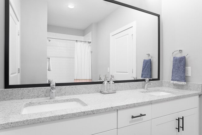 Explore this sleek bathroom featuring dual sinks and a touch of luxury. - Lemmond Farm