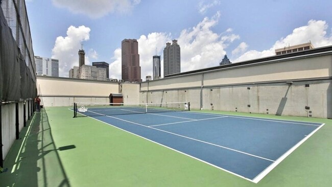 Rooftop tennis court with downtown skyline views - Piedmont Pad Apartments