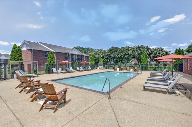 Community swimming pool with an expansive sundeck designed for recreation and relaxation. - Saddlebrook Apartments