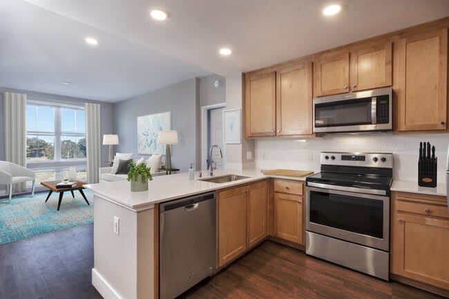 Renovated Package II Kitchen, living, and dining areas with hard surface flooring - Avalon San Bruno