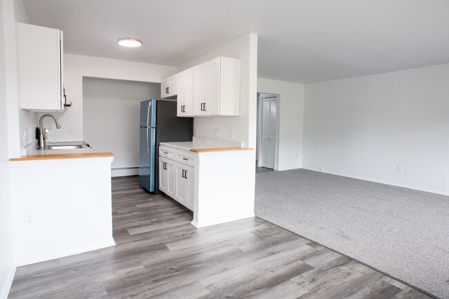 LIVING ROOM/DINING AREA AND KITCHEN- 1 AND 2 BEDROOM - Carriage Hill Apartments