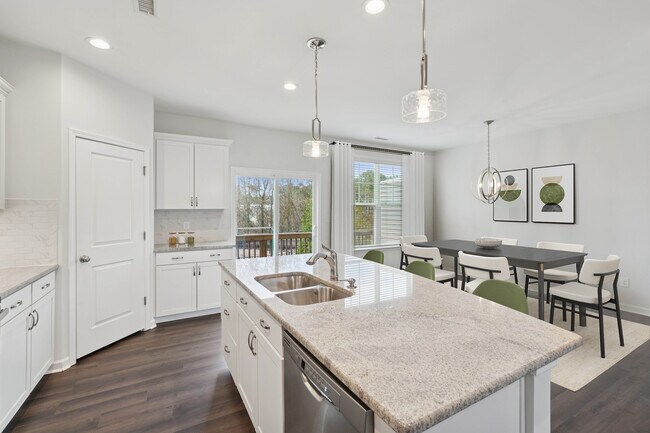 Upgrade Package Kitchen and dining area with hard-surface vinyl plank flooring - Avalon Townhomes Brier Creek