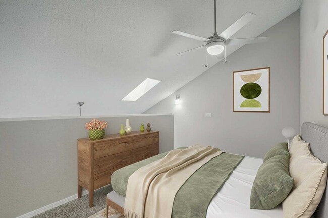 Bedroom with vaulted ceiling, skylight, ceiling fan, wood dresser, green accent bedding, and framed wall art - Walnut Creek
