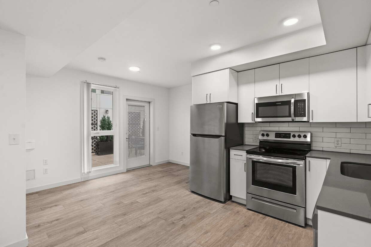 Modern kitchen with stainless steel appliances and patio access - Studio Deluxe w/Patio